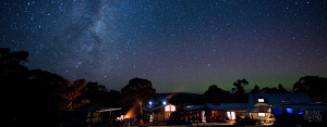 Bruny Island Lodge at nighttime with a spectacular night sky background containing the Milky Way and southern Aurora Australis